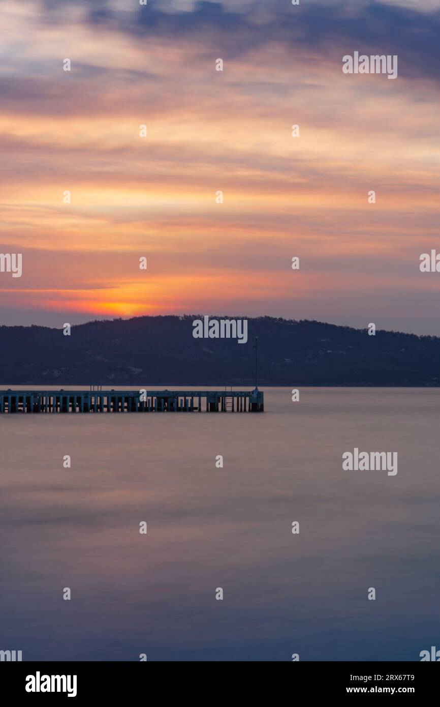 Colorful sunset at South Arm Peninsula jetty, Tasmania, Australia Stock Photo