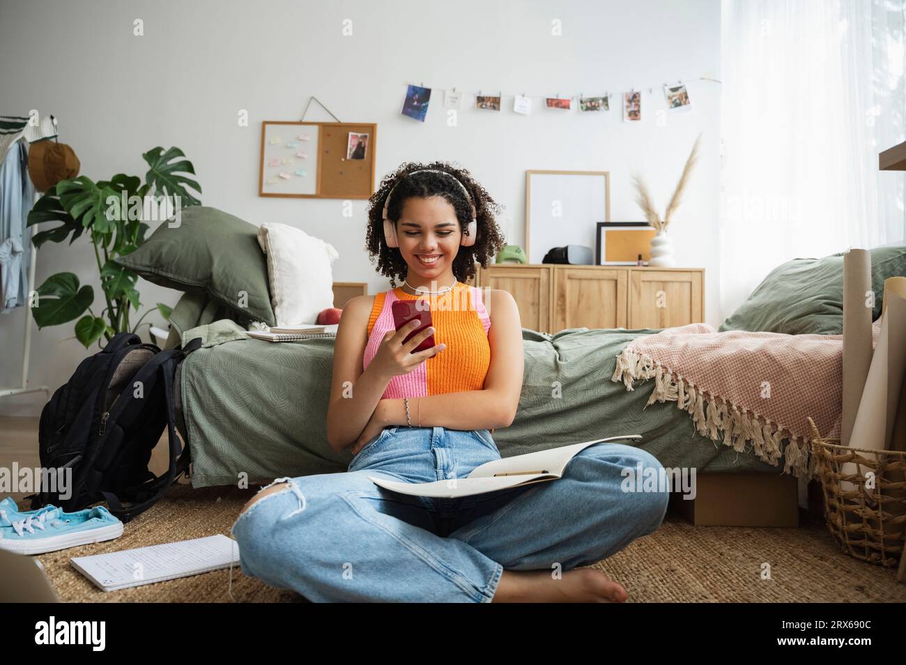 Happy teenage girl using mobile phone in bedroom at home Stock Photo ...