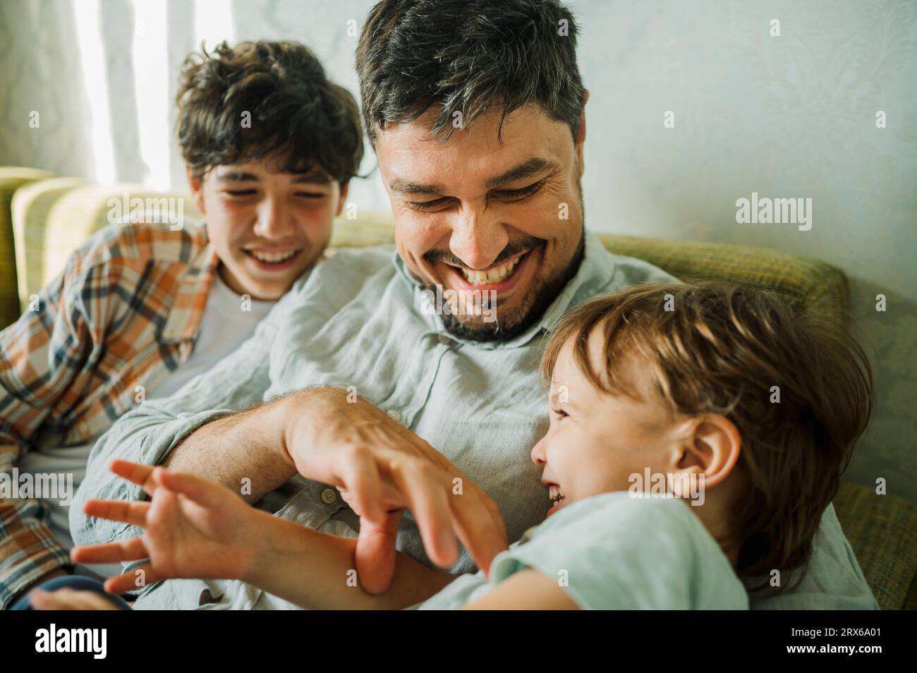 Happy father having fun with children at home Stock Photo