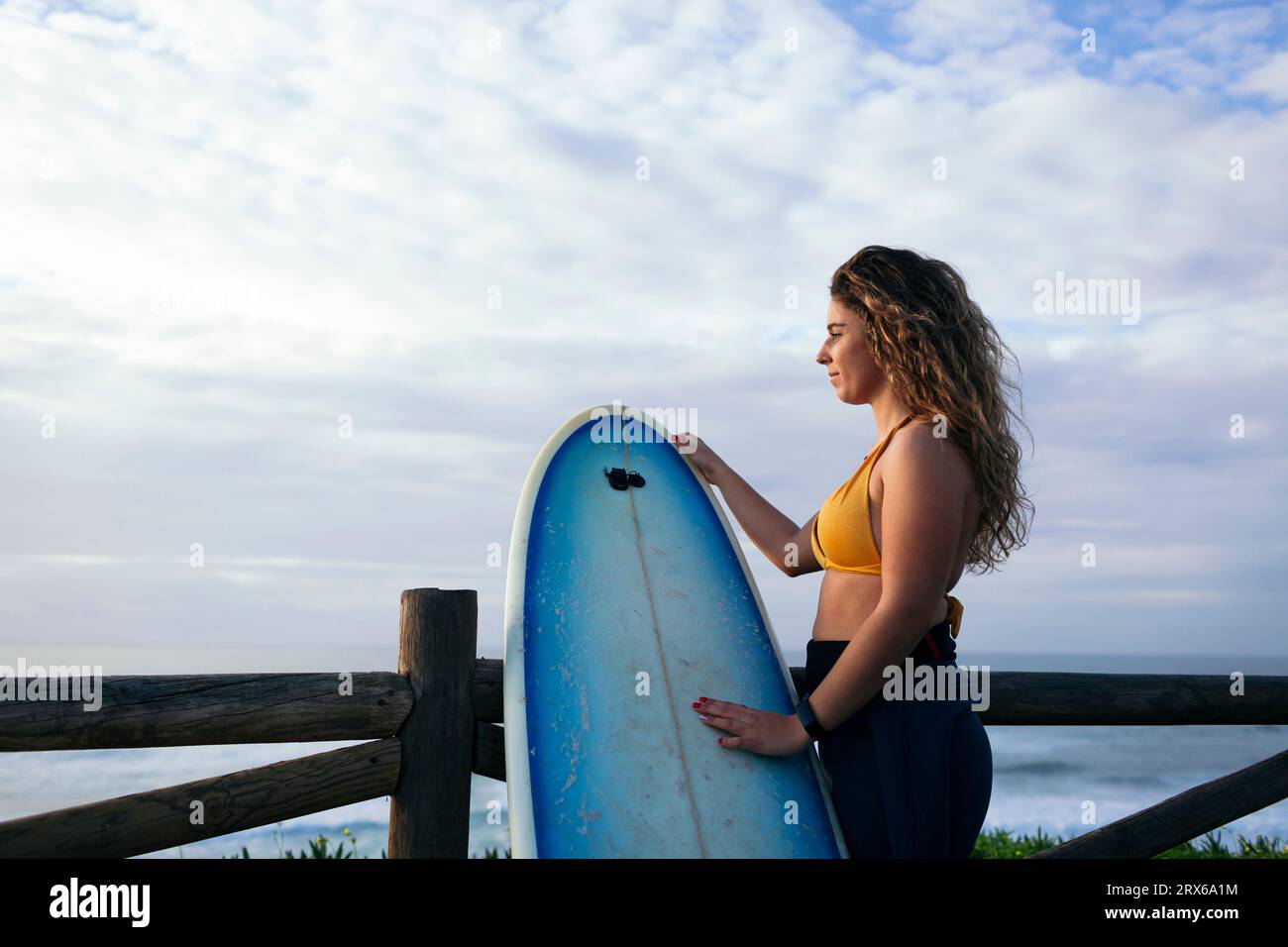 Young women holding surfboard hi-res stock photography and images - Alamy