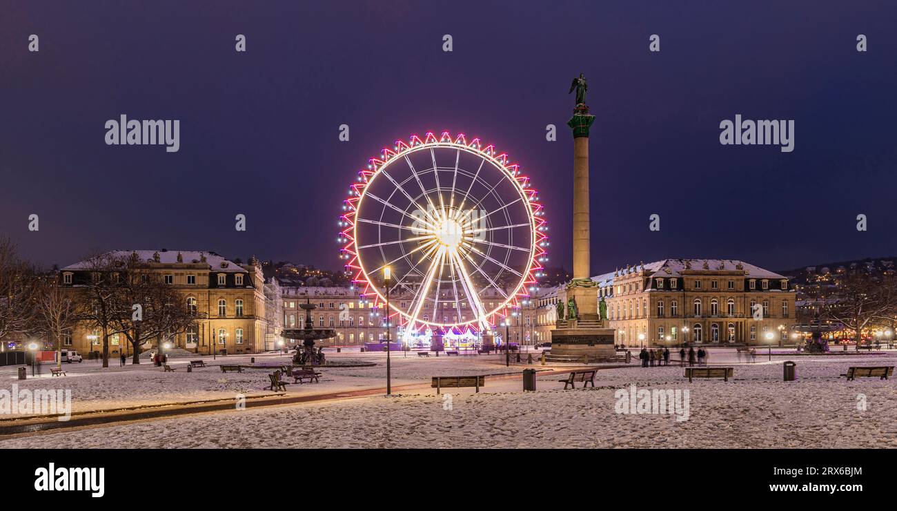 Germany, Baden-Wurttemberg, Stuttgart, Ferris wheel glowing at Schlossplatz square at night Stock Photo