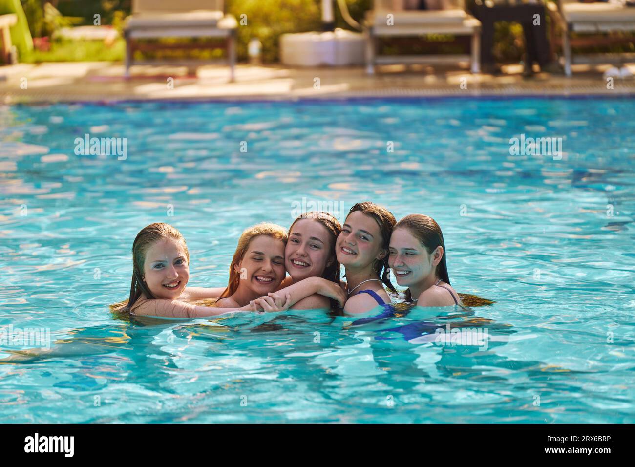 Happy friends enjoying in swimming pool on vacation Stock Photo - Alamy