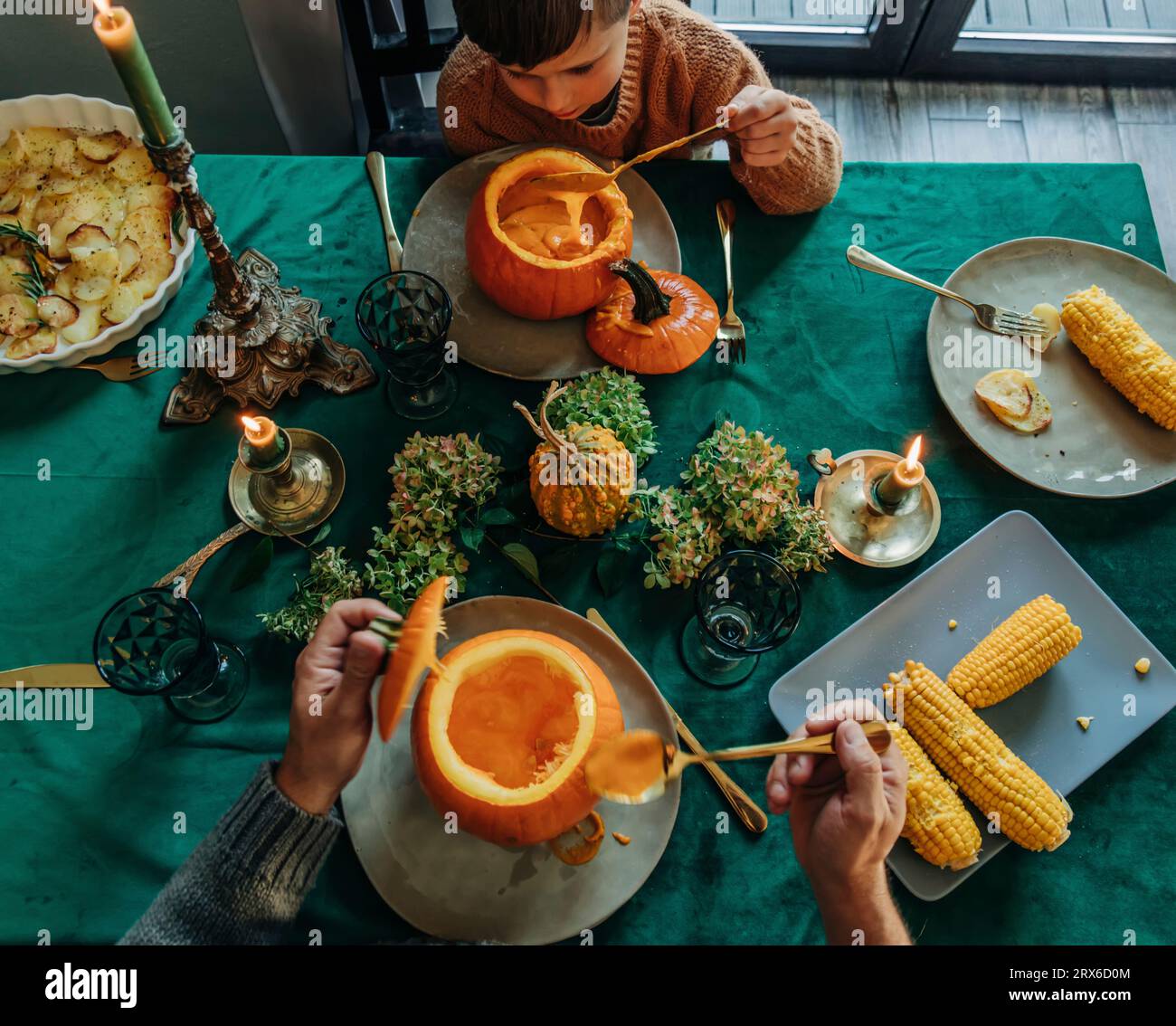 Father and son having thanksgiving dinner at table Stock Photo - Alamy