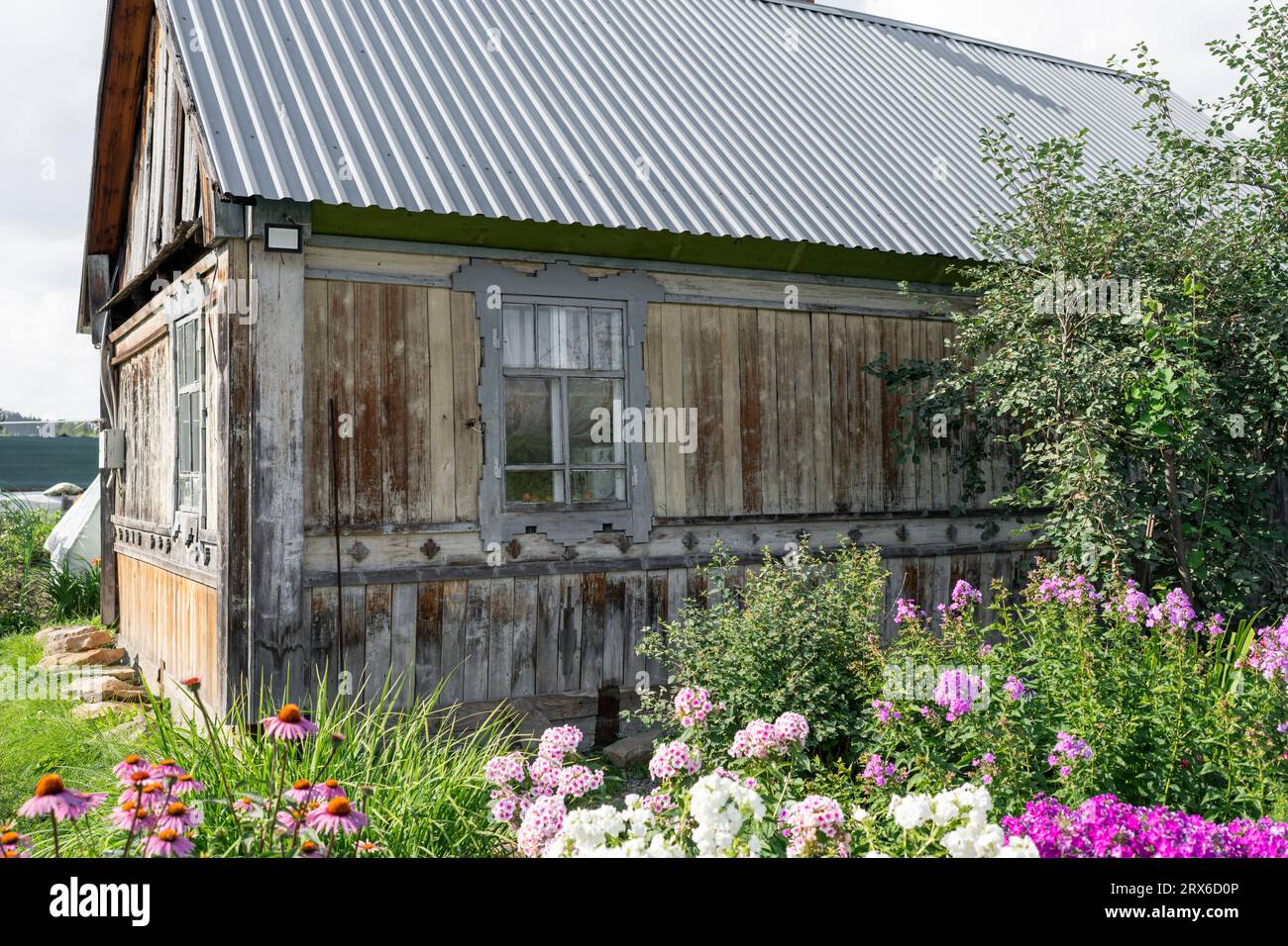 Old wooden house with garden in village Stock Photo - Alamy