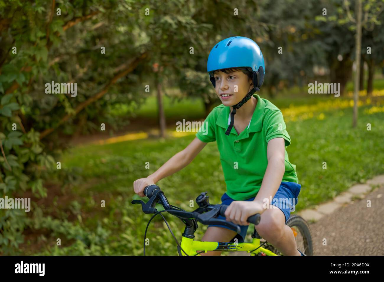 Cute little boy enjoying a bike ride in park Stock Photo Alamy