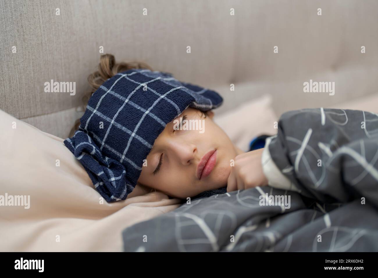 Cute boy having fever, wrapped with a blanket Stock Photo Alamy