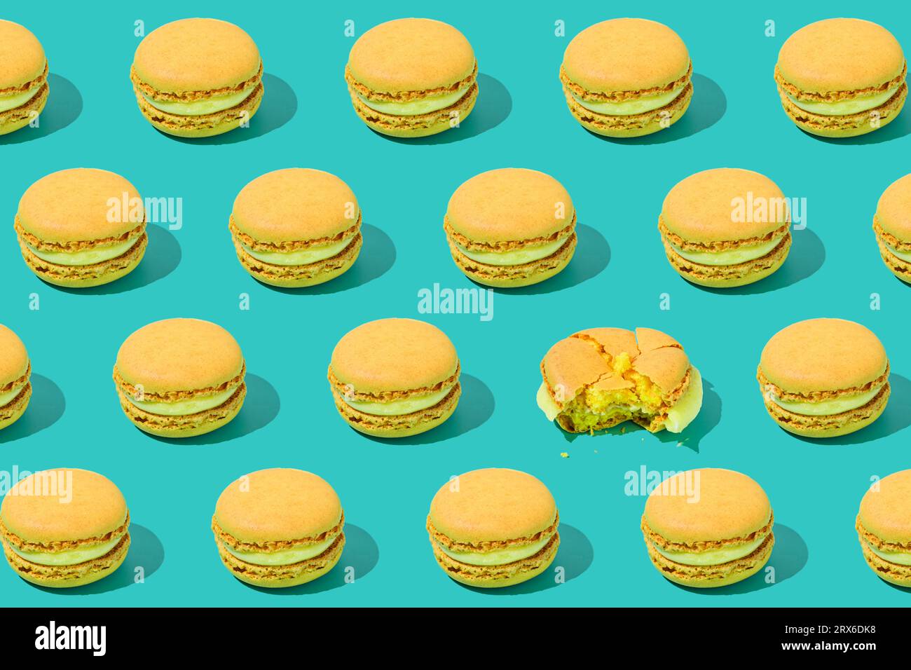 Yellow macaroons arranged on colored background Stock Photo