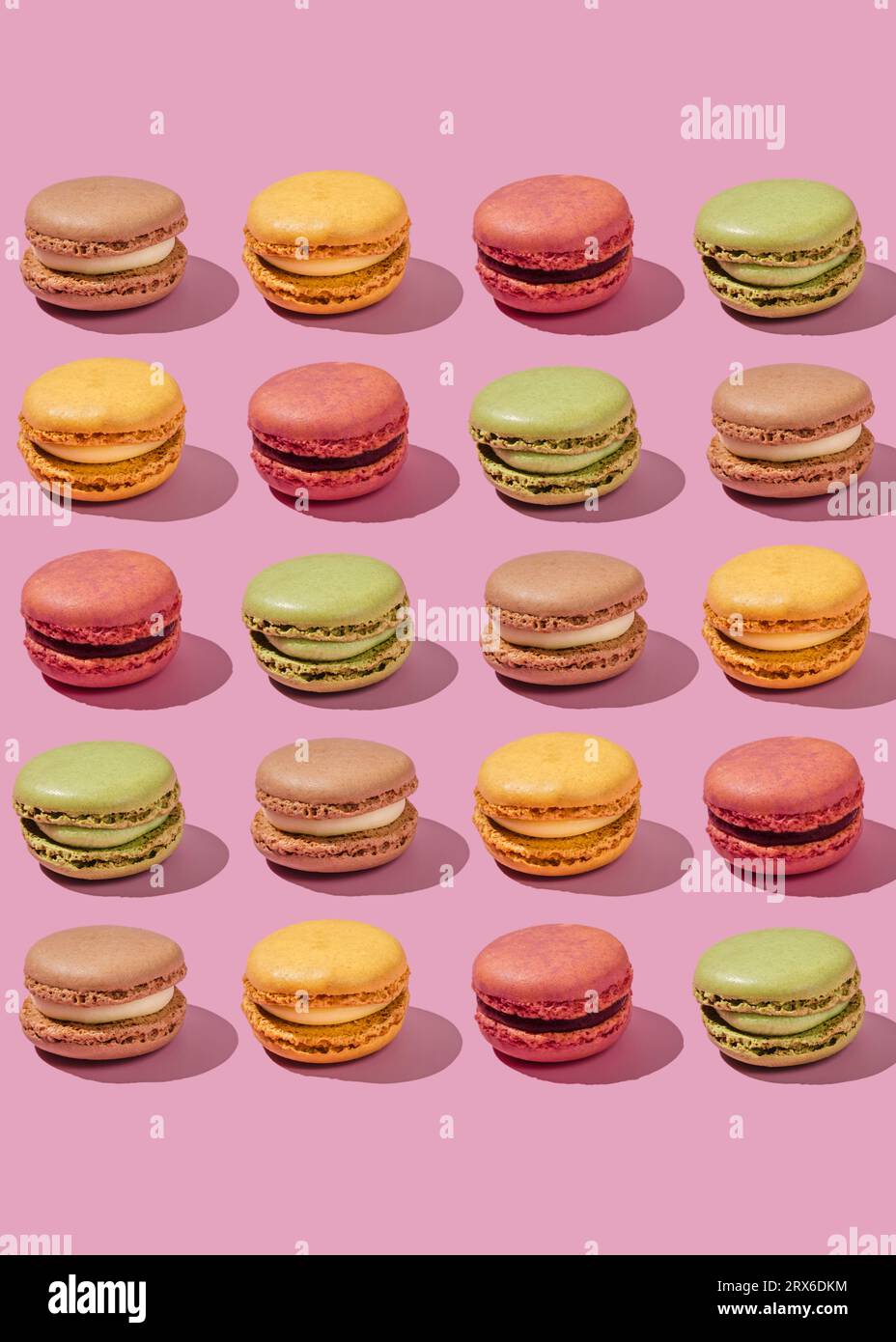 Multi colored macaroons arranged on pink background Stock Photo