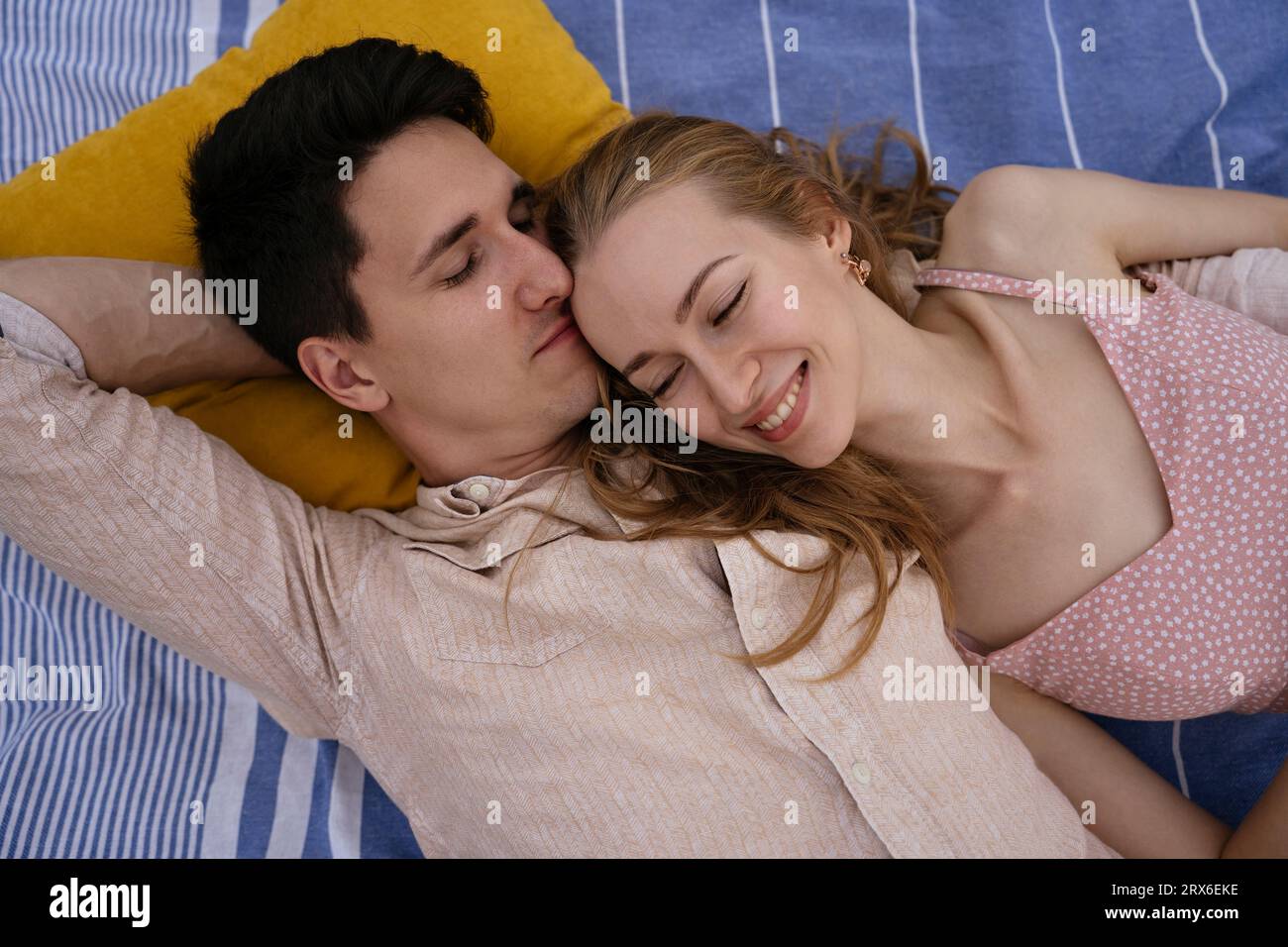 Young romantic couple lying together at beach Stock Photo - Alamy