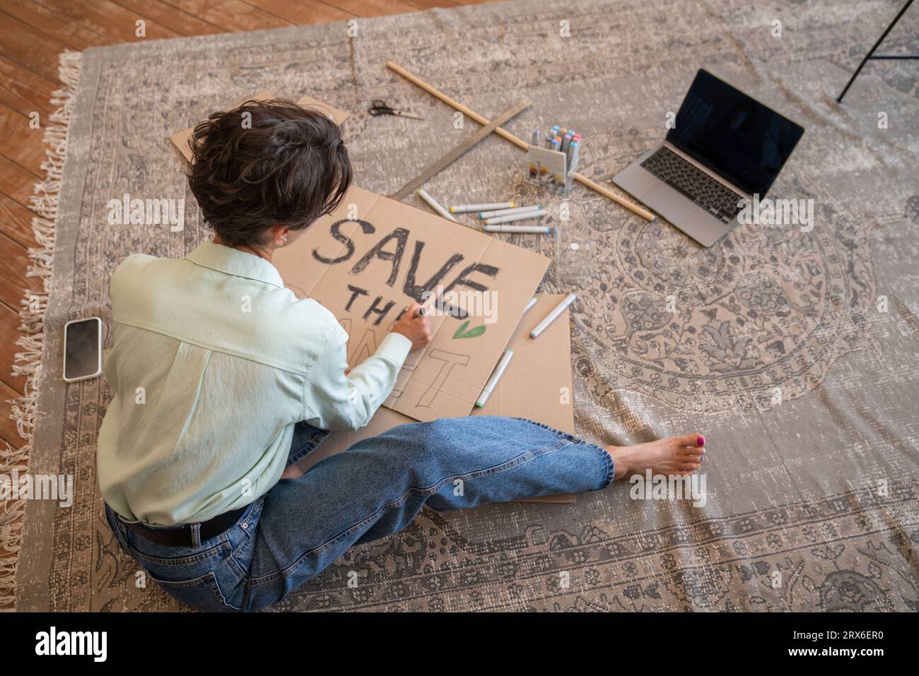 Activist making environment placard in living room Stock Photo