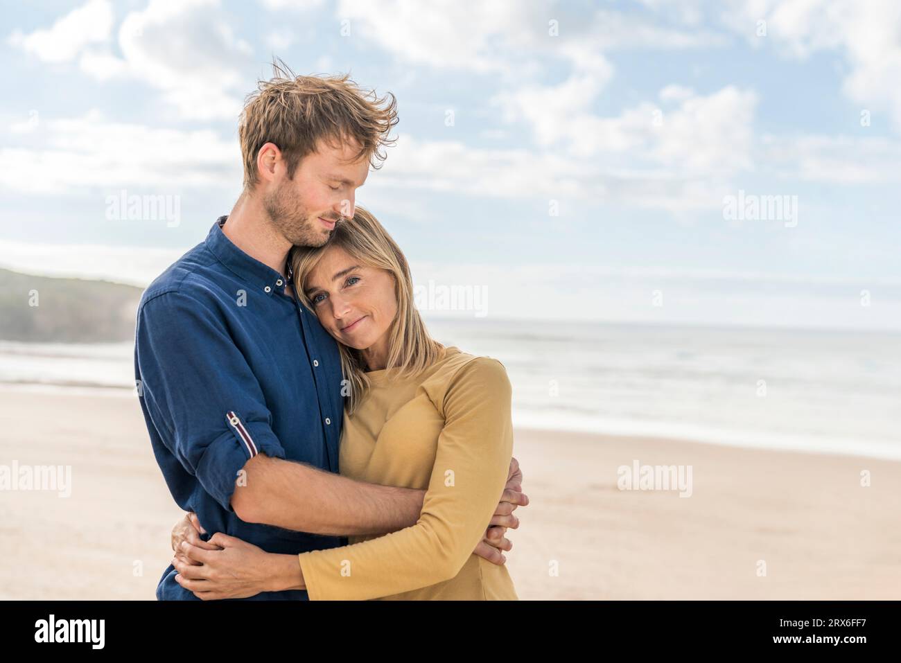 Happy man hugging woman at beach Stock Photo - Alamy