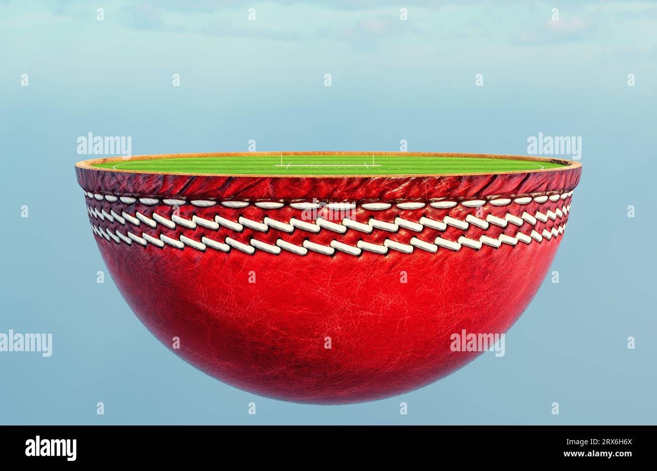 A cricket ball split in half revealing a marked green grass cricket