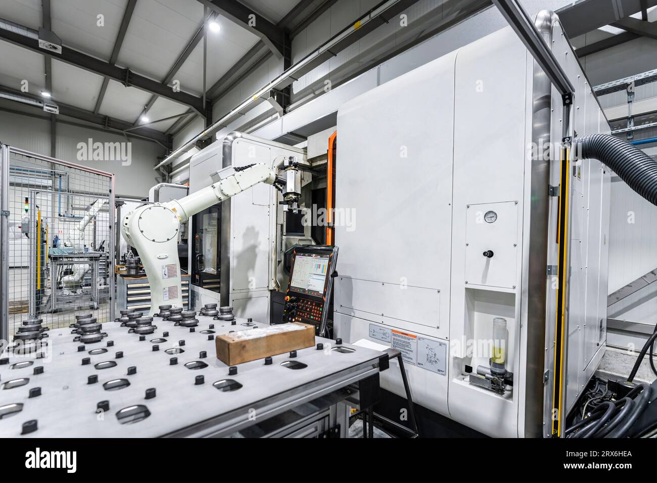 White robotic arm with cnc machinery in metal industry Stock Photo - Alamy