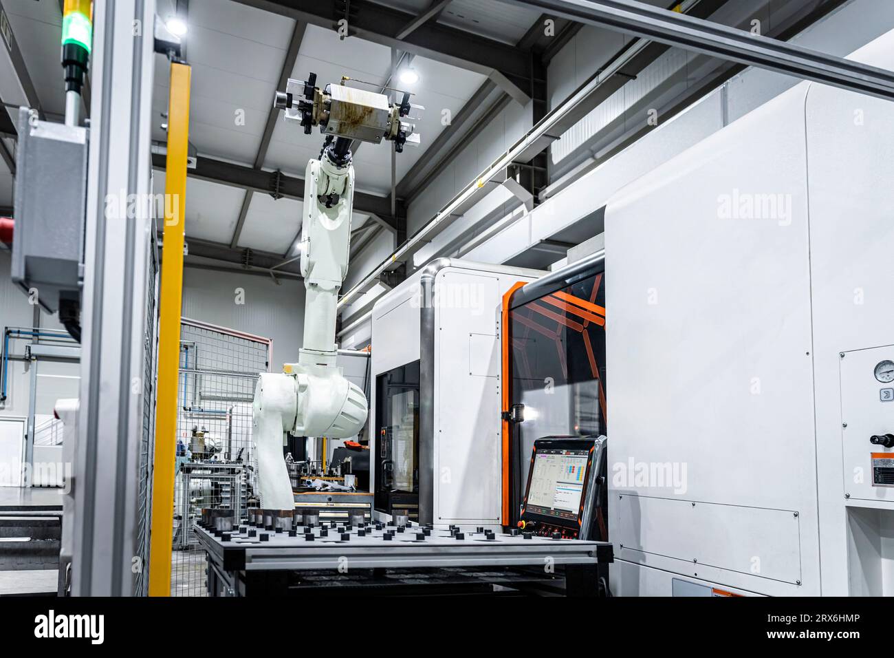 White robotic arm with cnc automated machinery in factory Stock Photo ...