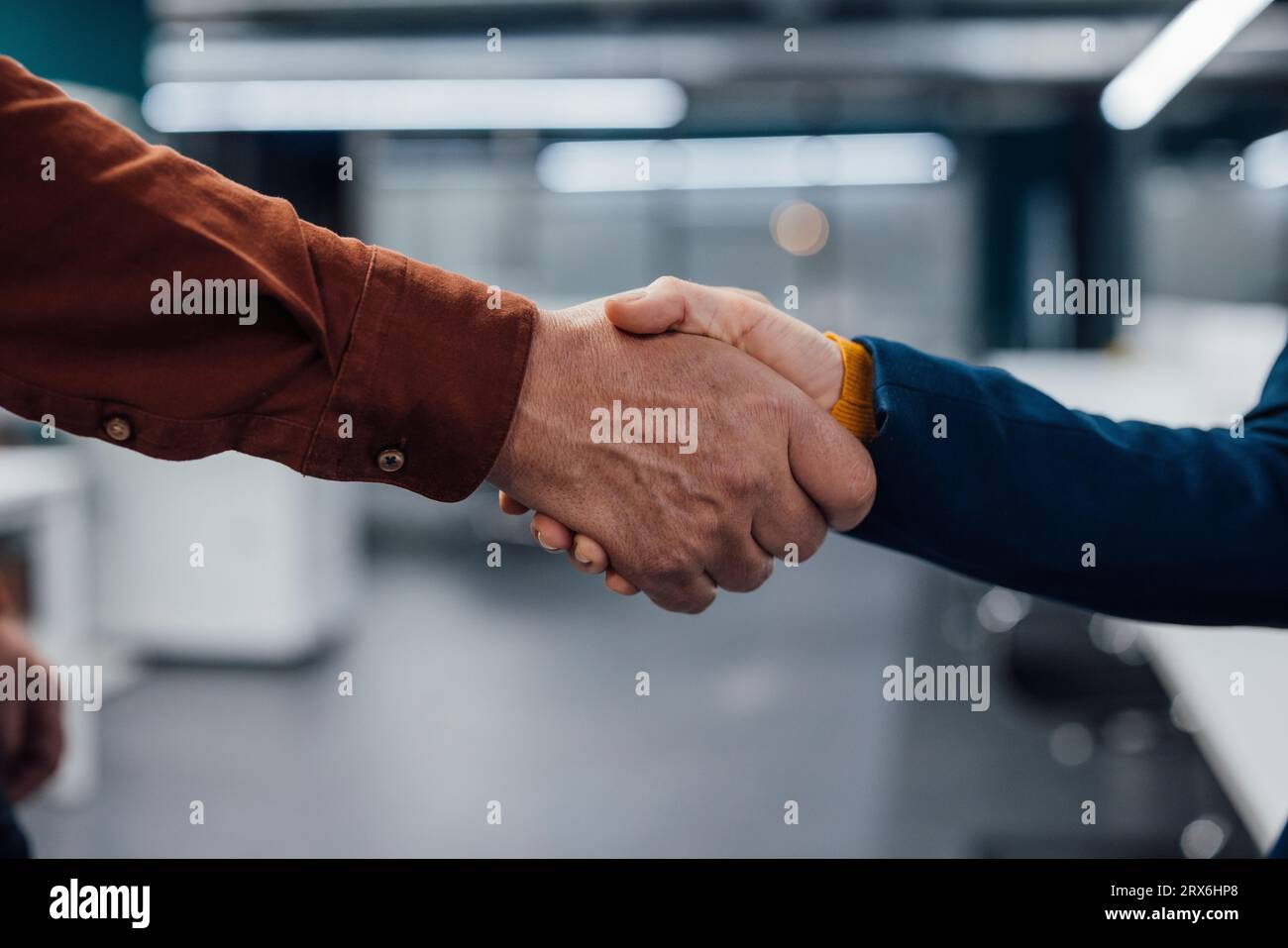 Hands of business colleagues shaking hands at work place Stock Photo