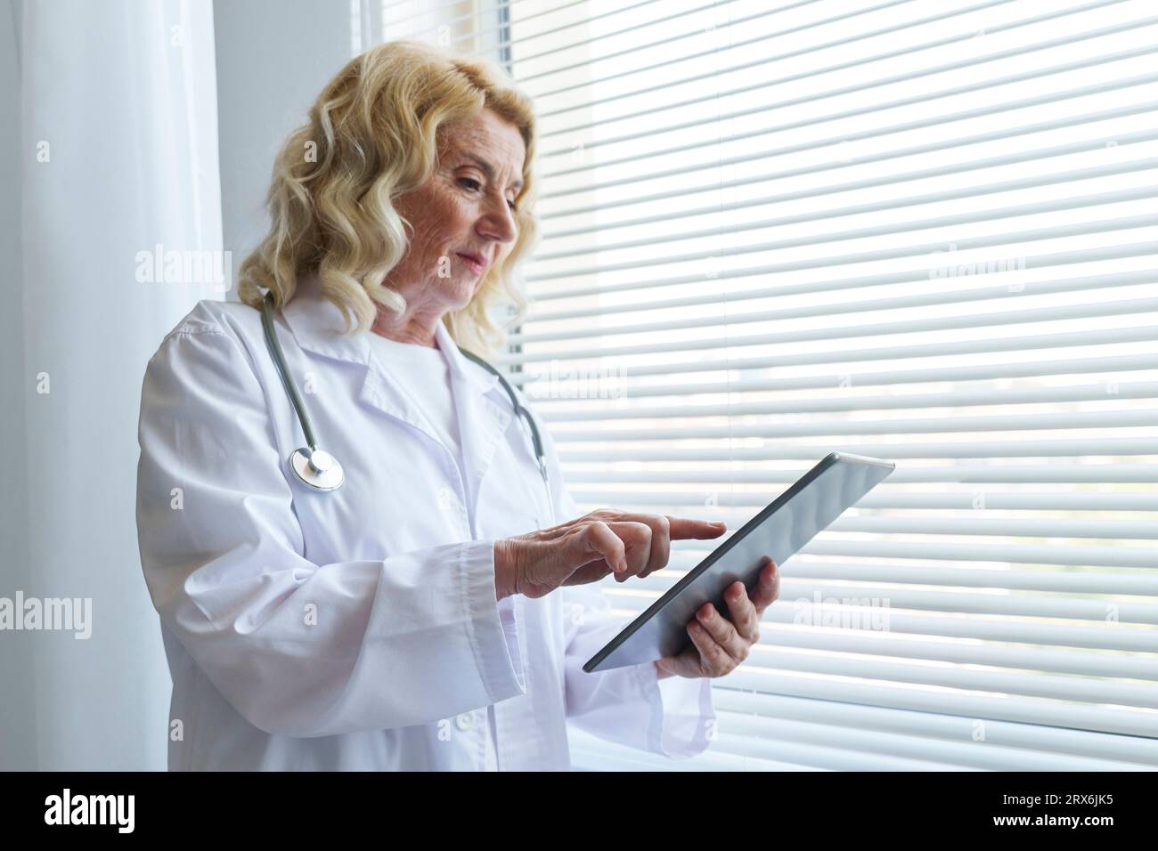 Female doctor touching senior hi-res stock photography and images - Alamy