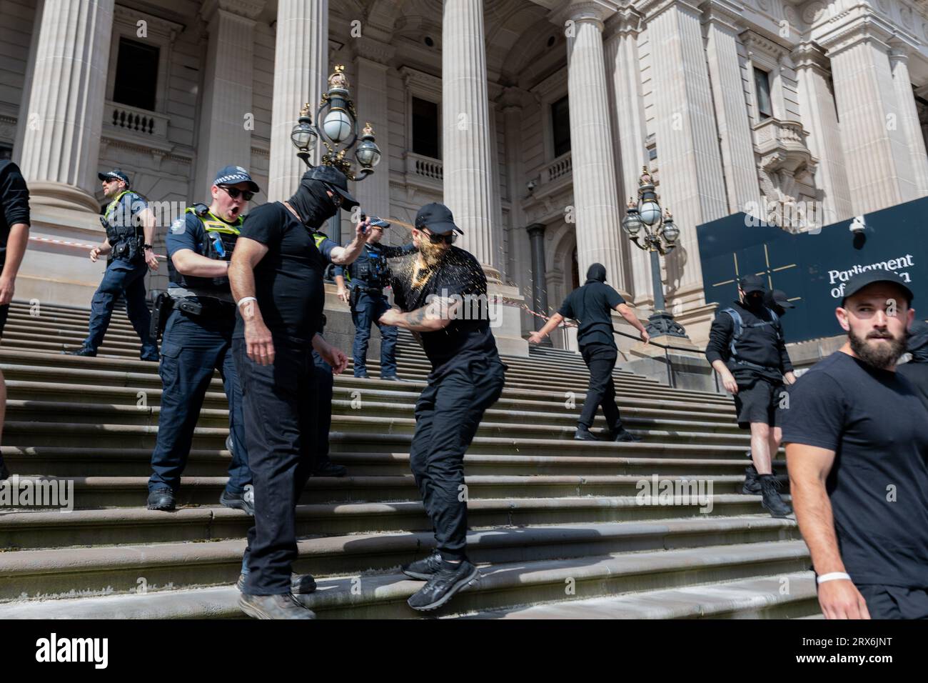 Melbourne, Australia, September 23rd 2023. Neo-Nazi boxing gym director Timothy Lutze is pepper sprayed by police while being forced off the stairs of Parliament House after supporting a 'Vote No' rally. Credit: Jay Kogler/Alamy Live News Stock Photo