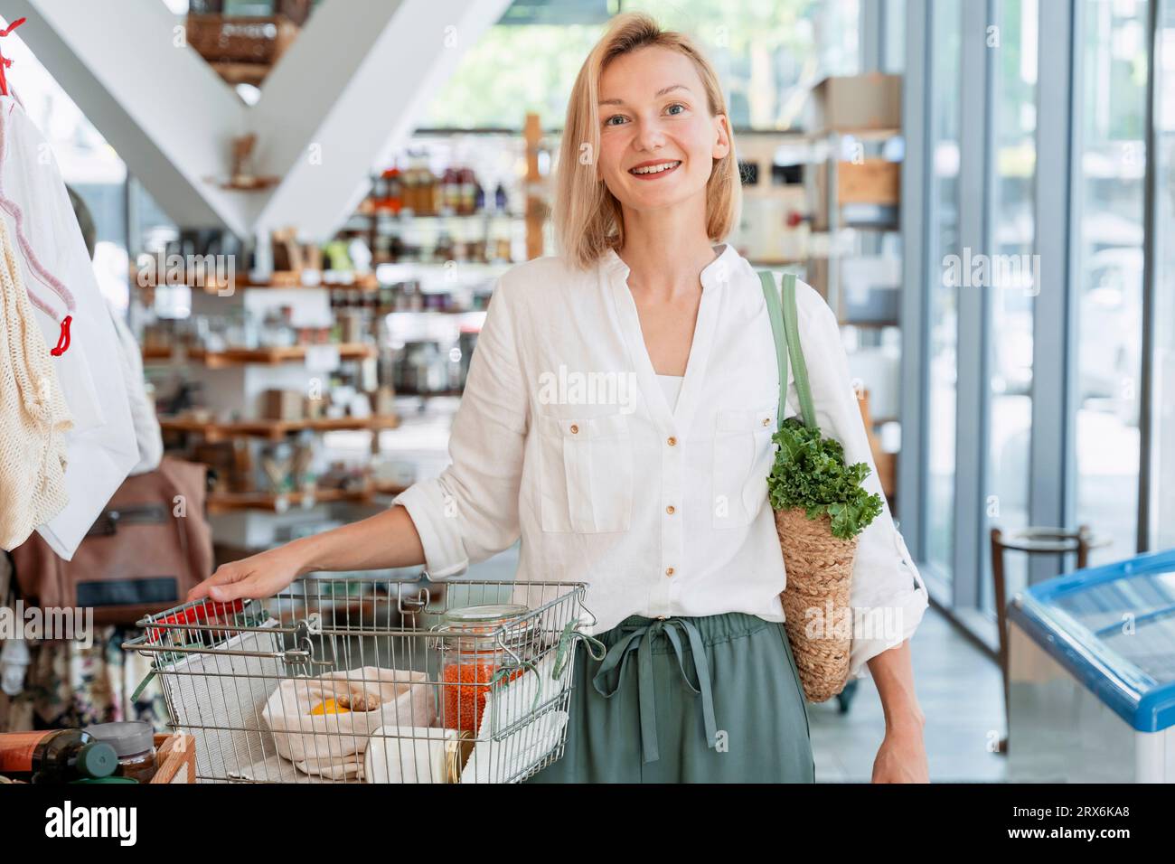 Happy woman shopping groceries in store Stock Photo