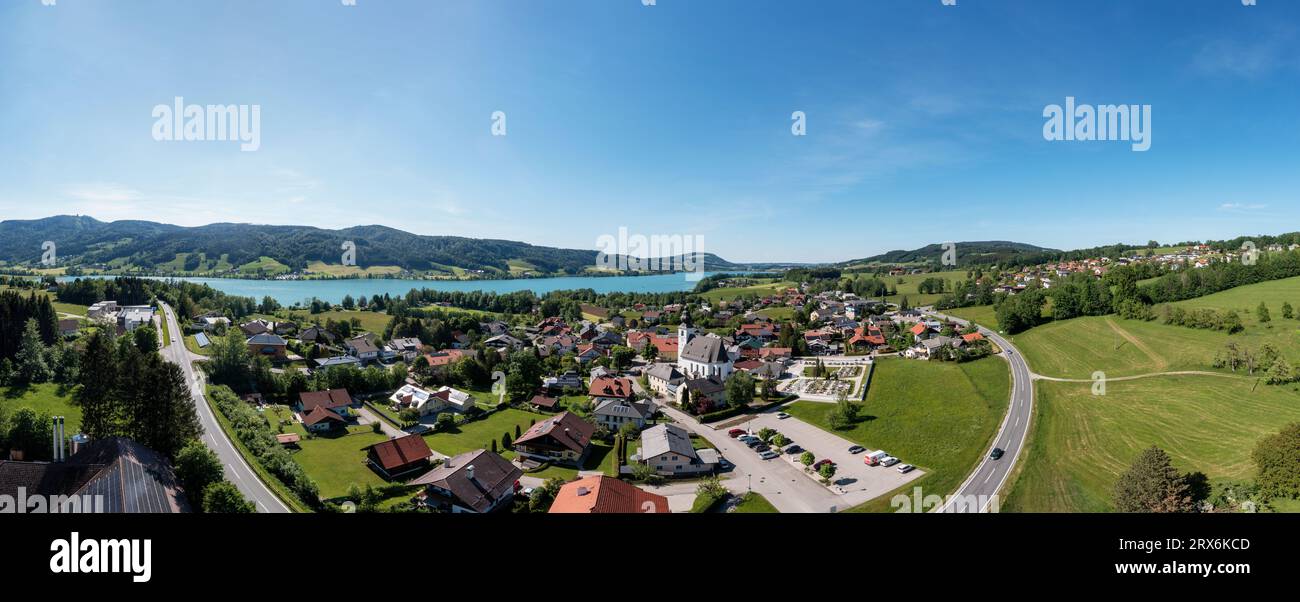 Austria, Upper Austria, Zell am Moos, Drone panorama of lakeshore town in summer Stock Photo