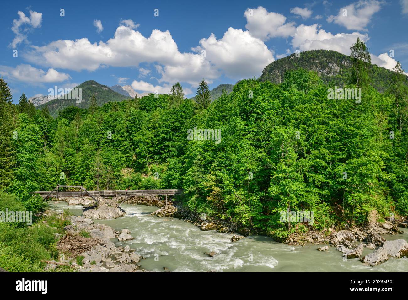 Wooden bridge over river in forests of Berchtesgaden Alps under cloudy ...