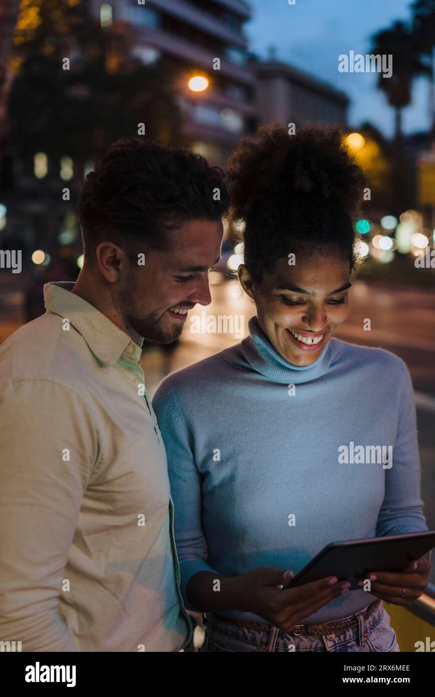 Happy businessman with colleague using tablet PC Stock Photo