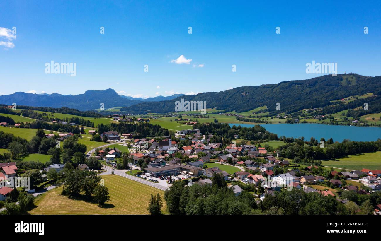 Austria, Upper Austria, Zell am Moos, Drone panorama of village on shore of Irrsee lake in summer Stock Photo