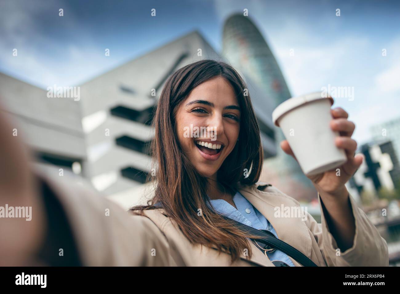 Happy young woman taking selfie with coffee cup Stock Photo