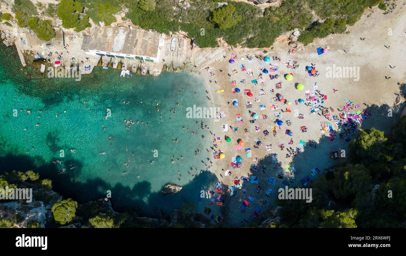 Picture dated June 25th shows a drone image of busy beach in Cala Pi in Majorca in the  Balearic Islands,Spain. Stock Photo