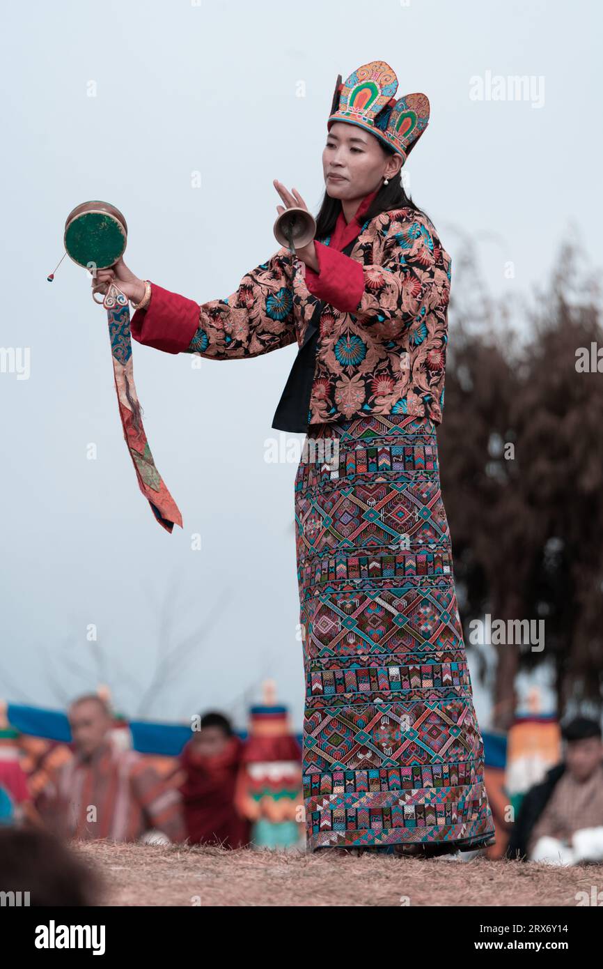 Beautiful woman performing ritual dance in colorful attire Stock Photo