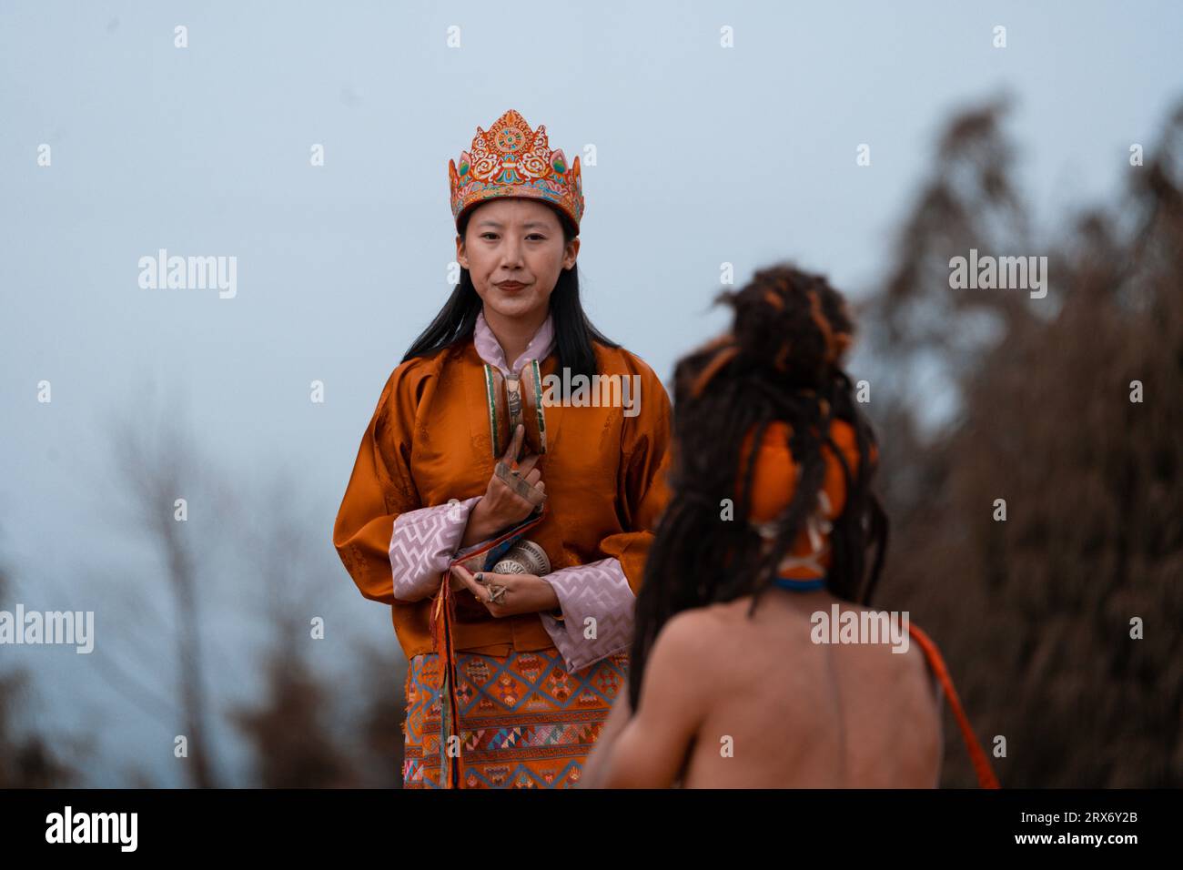 Beautiful woman performing ritual dance in colorful attire Stock Photo