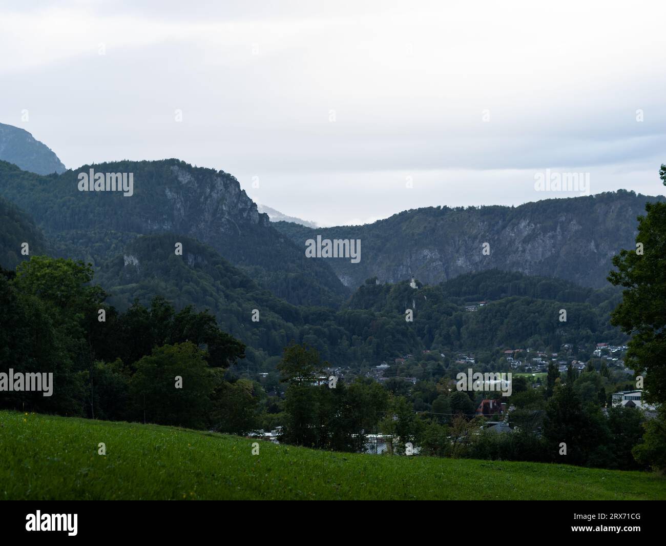 Mountain landscape in Bad Reichenhall in Bavaria, Germany. Small town in the valley surrounded by the German Alps. Rainy weather and an overcast sky. Stock Photo