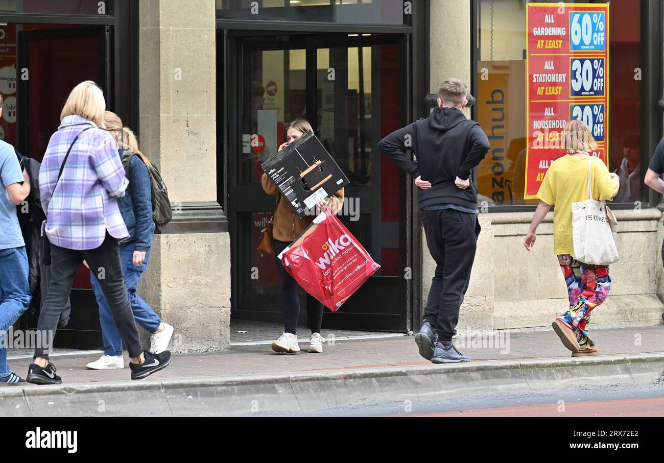 Bristol, UK. 23rdSeptember 2023. Lone Person with large Parcels leaving front entrance of Wilko Store in Bristol which is closing down. Last minute bargain's Picture Credit: Robert Timoney/Alamy Live News Stock Photo