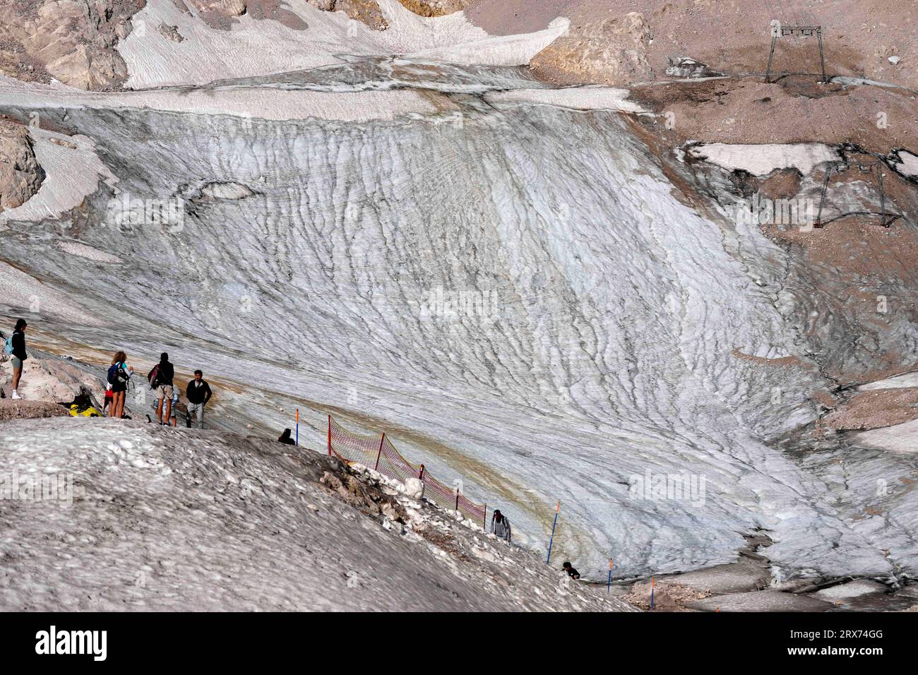 People enjoy the sunny day at a toboggan run for tourists at the