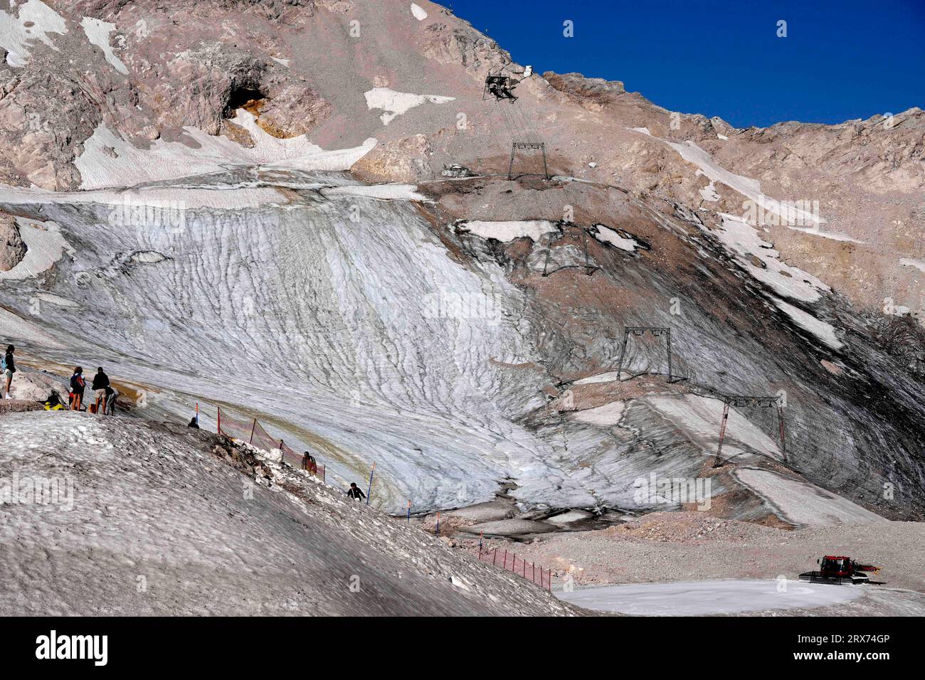 People enjoy the sunny day at a toboggan run for tourists at the