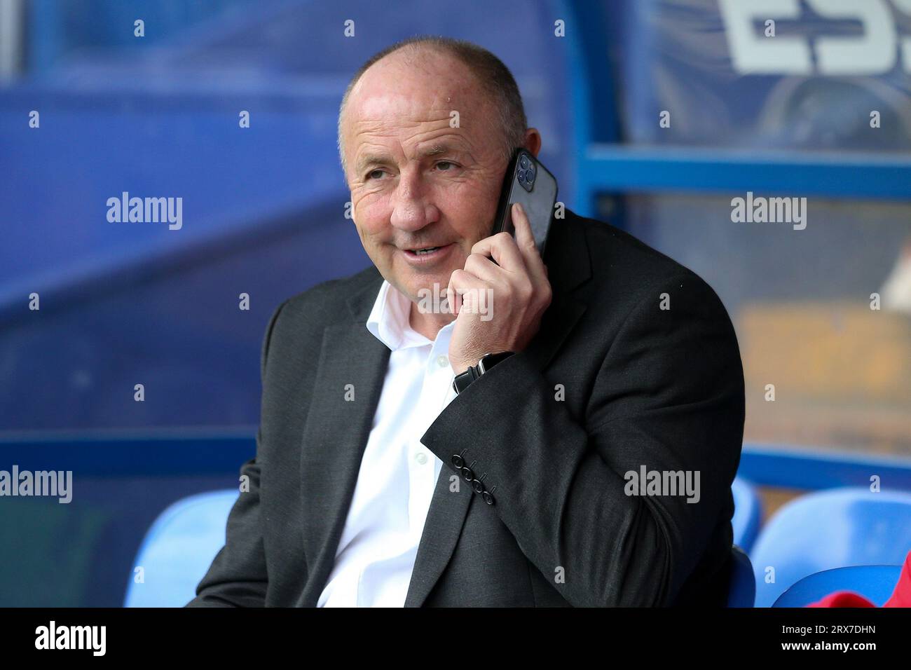Birkenhead, UK. 23rd Sep, 2023. John Coleman, the Manager of Accrington Stanley sits in the dugout while talking on his mobile phone. EFL Skybet Football league two match, Tranmere Rovers v Accrington Stanley at Prenton Park, Birkenhead, Wirral on Saturday 23rd September 2023. this image may only be used for Editorial purposes. Editorial use only, .pic by Chris Stading/ Credit: Andrew Orchard sports photography/Alamy Live News Stock Photo