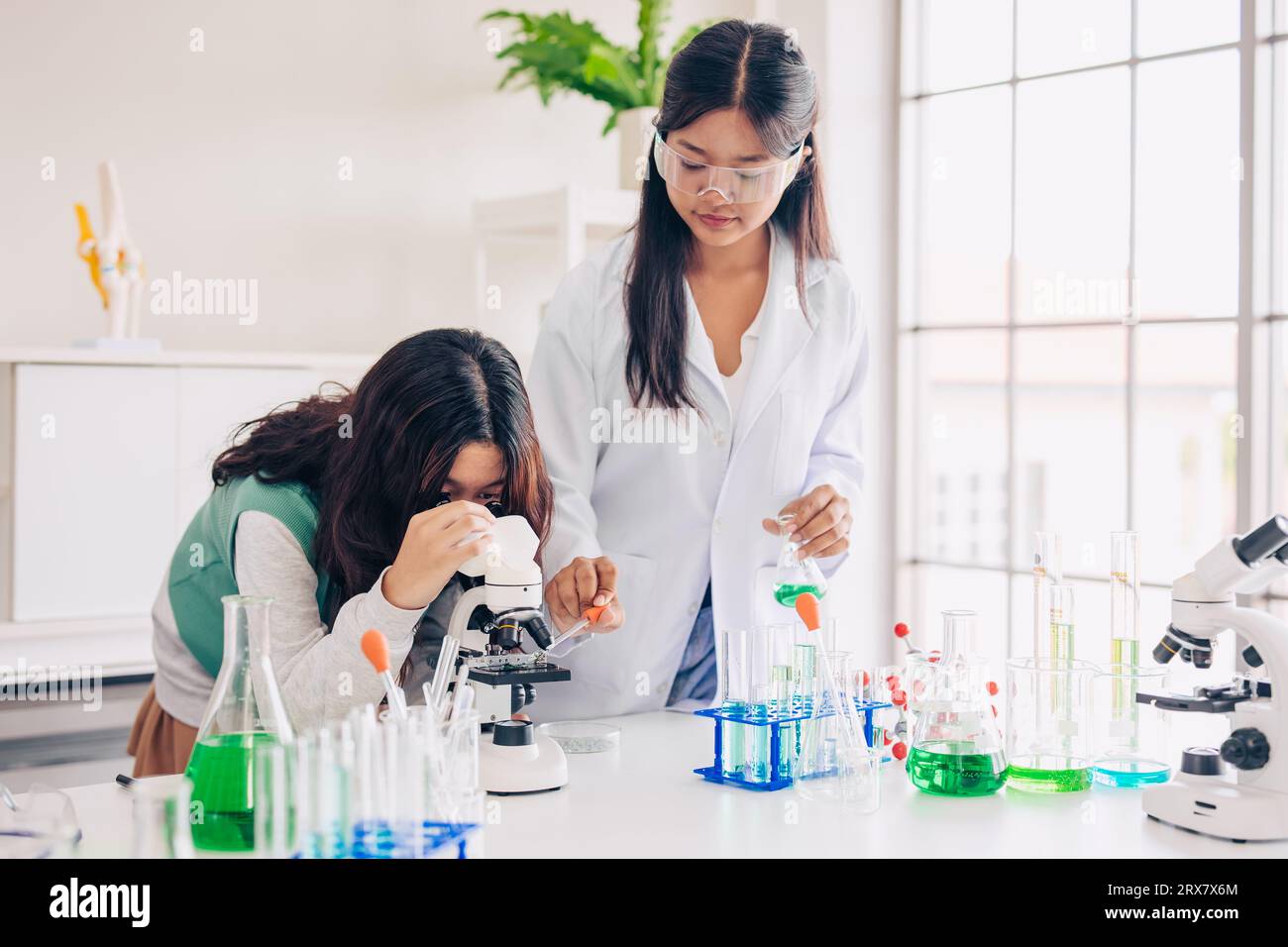 Children teen role playing scientist at fun science chemical lab workshop for learning education in school Stock Photo