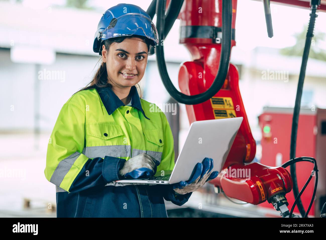 Portrait Indian young smart engineer woman worker confident look with safety suit work in advance technology industry Stock Photo