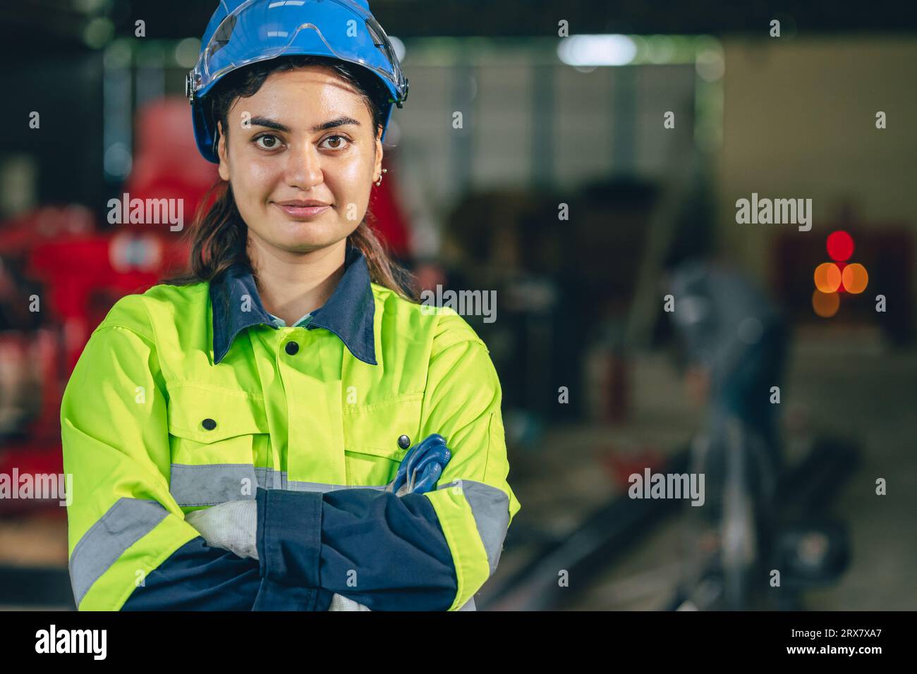 Portrait Indian young smart engineer woman worker confident look with safety suit work in advance technology industry Stock Photo