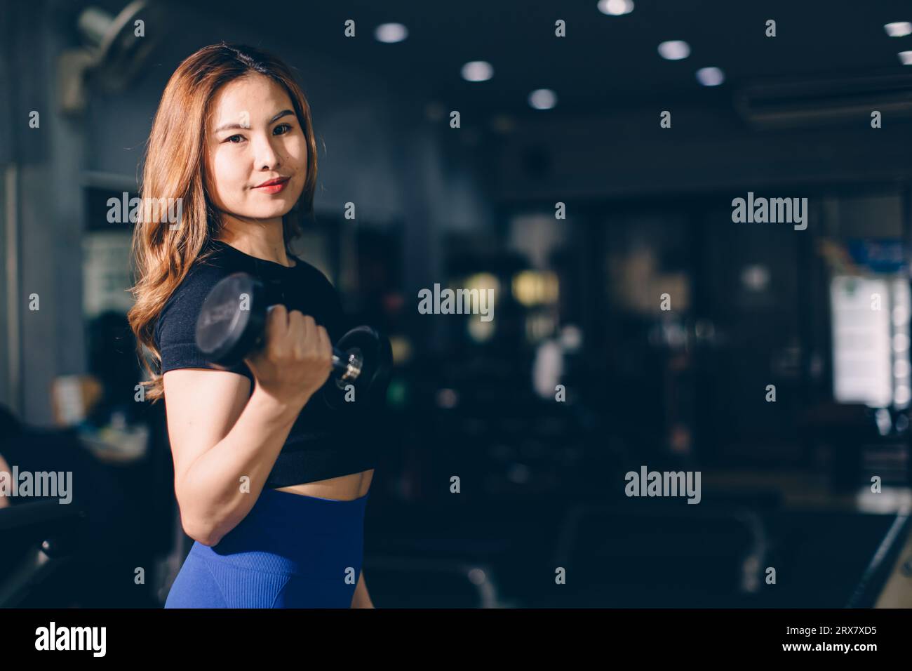 Portrait Happy sport Asian woman bodybuilding advertising athlete model muscle training in fitness gym sport club Stock Photo