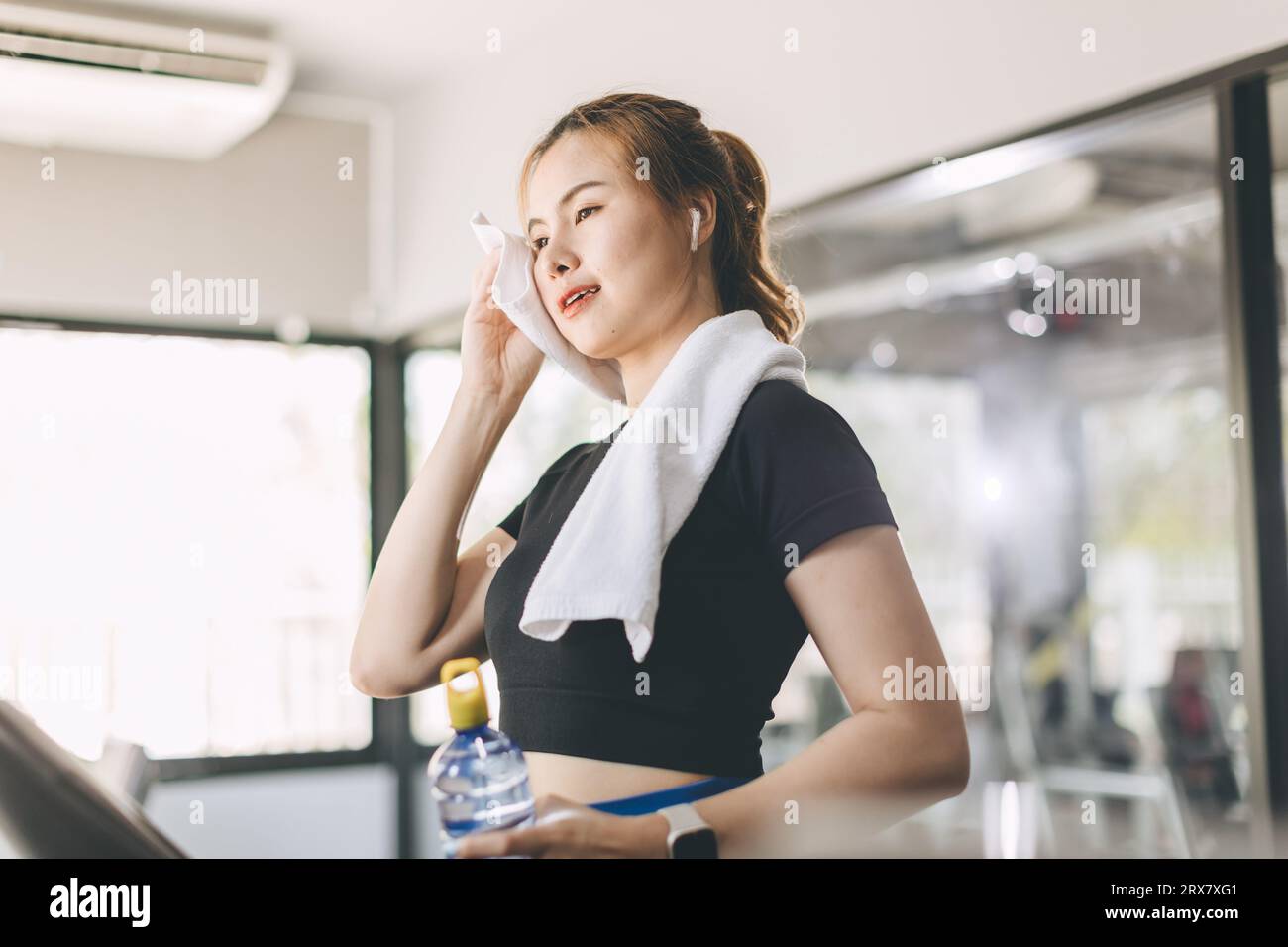 Young people running on a treadmill in health club. Sport fitness healthcare and healthy lifestyle concept. Stock Photo