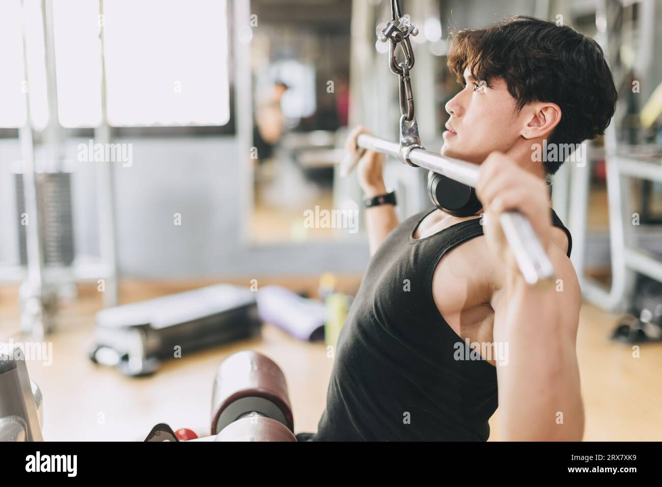 Asian Fitness Male Pull Exercises for Chest and Shoulder Muscle Strength Training in Sport Club Stock Photo