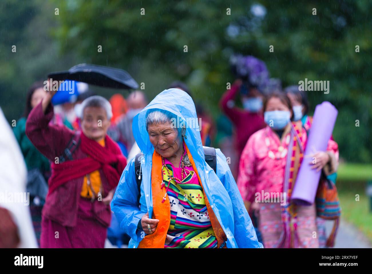 Old lady with raincoat Stock Photo - Alamy