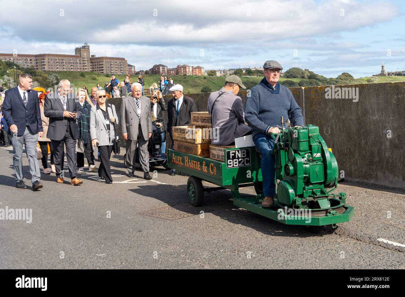 Community parade, ahead of unveiling of The Herring Girl statue, in North Shields, North Tyneside, UK, featuring the restored 1965 Fish Quay Popper Stock Photo