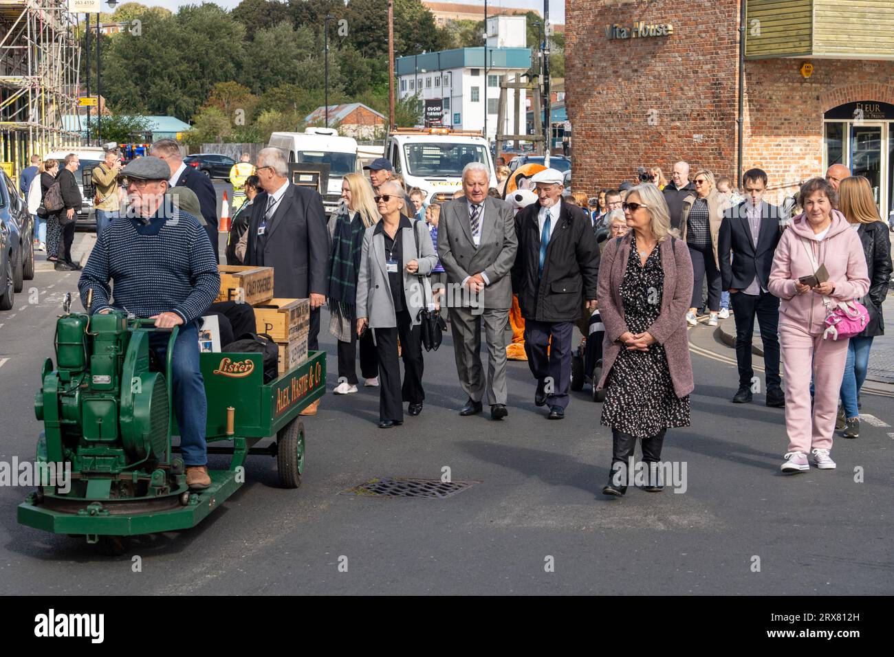 Community parade, ahead of unveiling of The Herring Girl statue, in North Shields, North Tyneside, UK, featuring the restored 1965 Fish Quay Popper Stock Photo