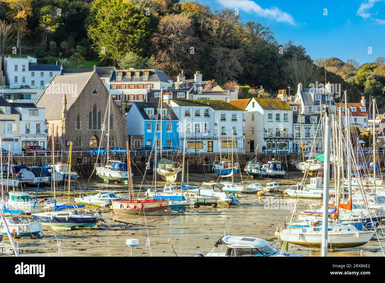 Saint Aubin town seashore view with Sacred heart of Jesus church,, and lots of yachts, bailiwick of Jersey, Channel Islands, Great Britain Stock Photo