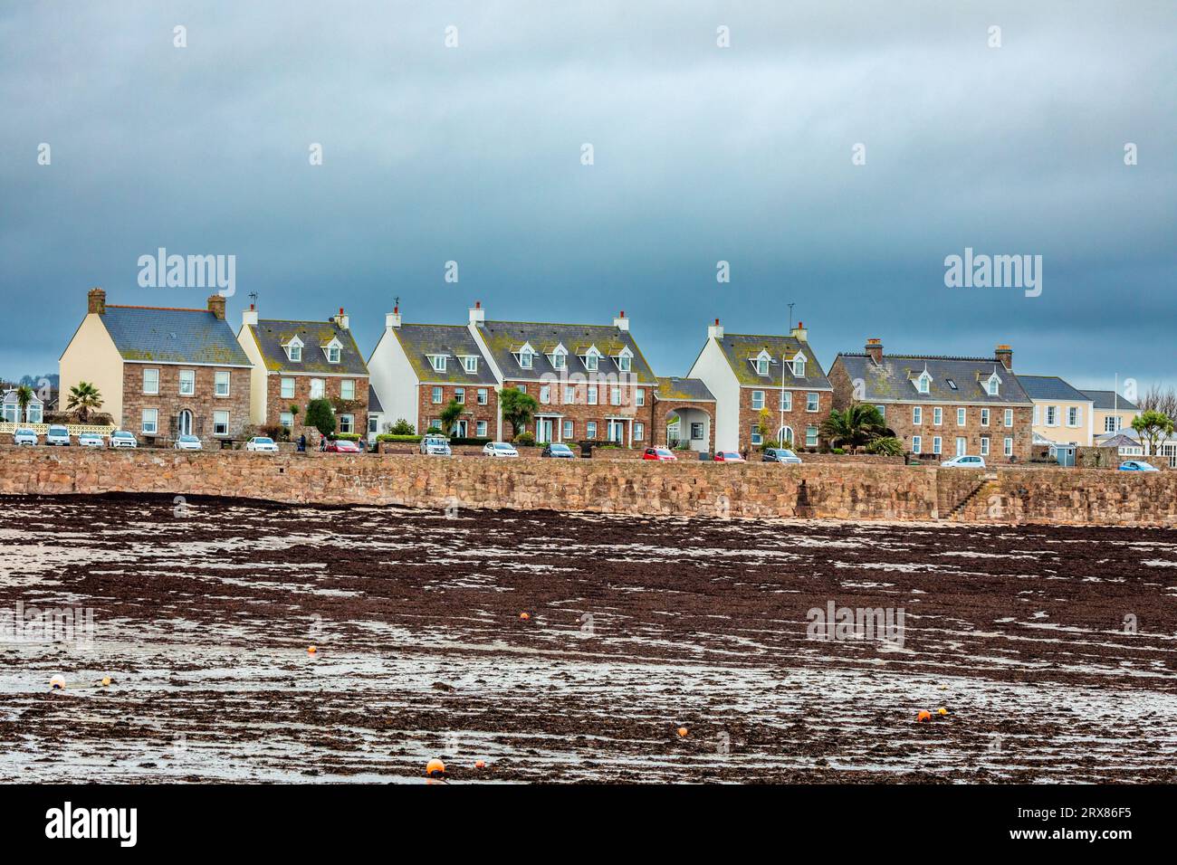 Residential houses on the La Manche seashore, in low tide bailiwick of Jersey, Channel Islands, Great Britain Stock Photo