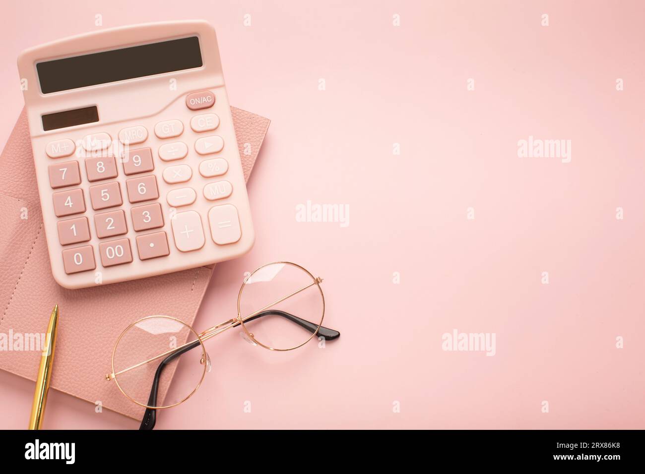 On a pink background, pink school supplies, a calculator, cheat