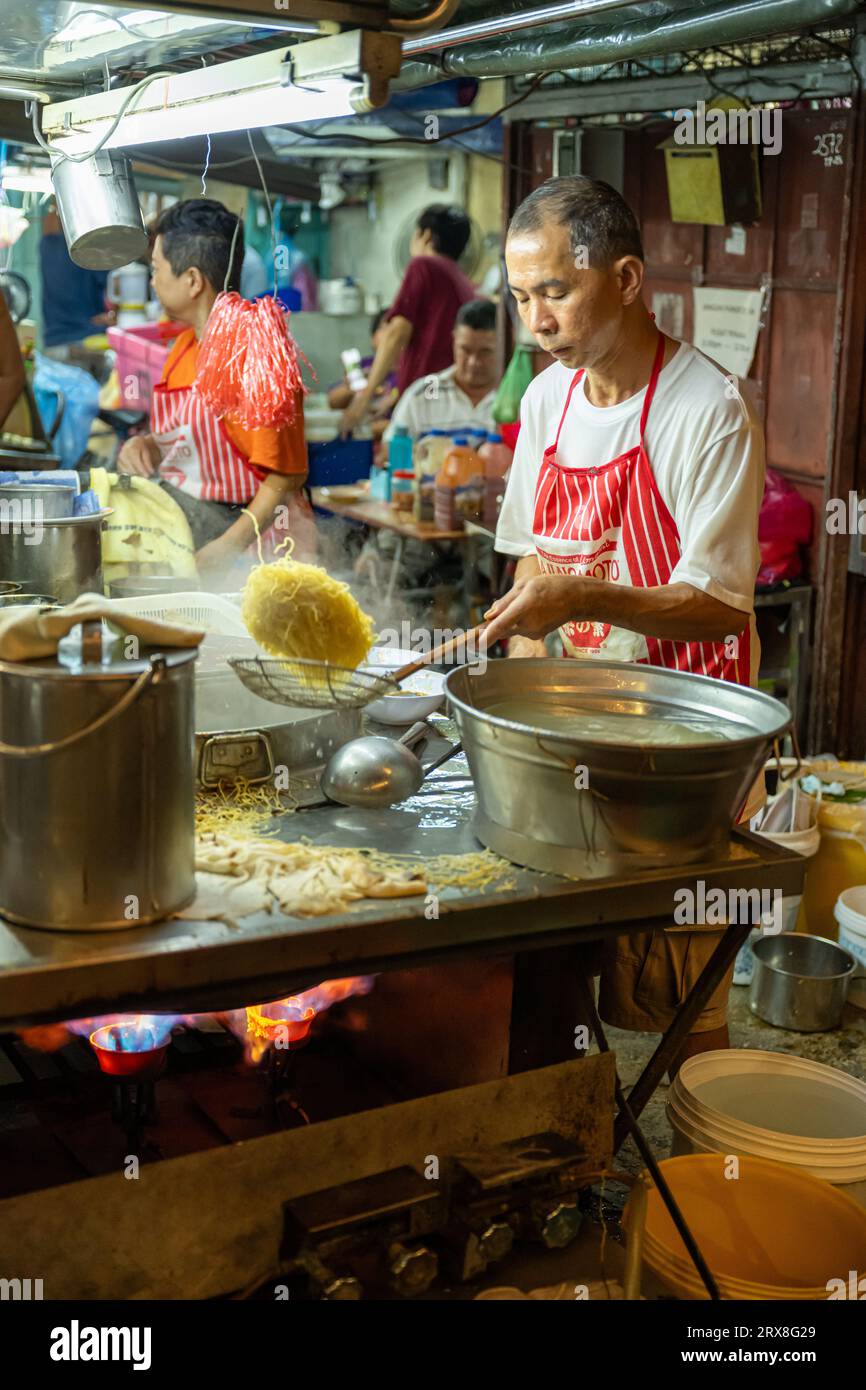 Preparing Char Kaoy Teow on Lebuh Carnarvon (Food Street),