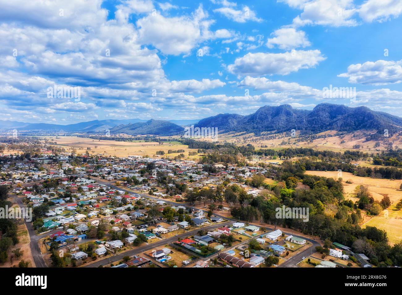 Scenic valley with Gloucester town at Barrington tops mountains in Australia aerial townscape
