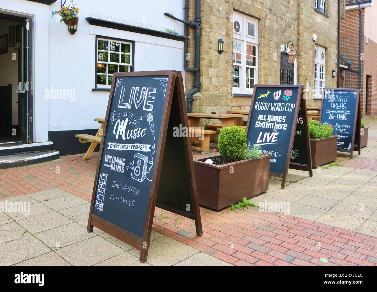 Exterior of The Oak public house with a-frame picnic table outdoor seating and chalk boards advertising the Rugby World Cup Sevenoaks Kent England UK Stock Photo